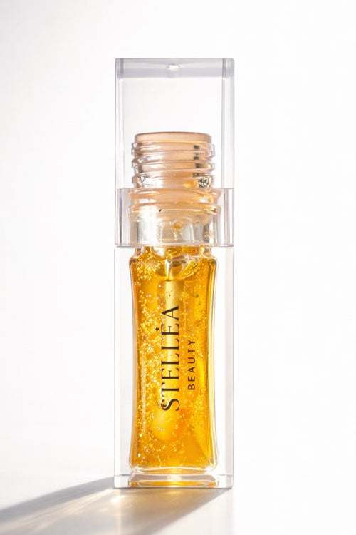 Huile à lèvres brillante STELLEA Coral en flacon transparent avec texture dorée aux reflets glossy